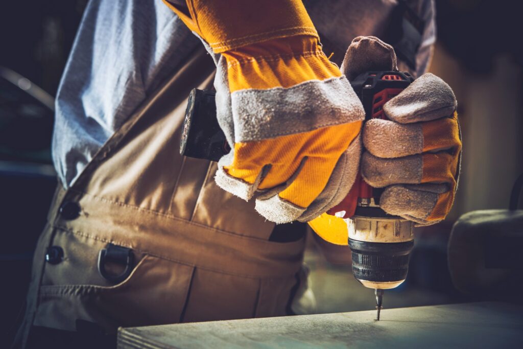 Drill and man with gloves on.